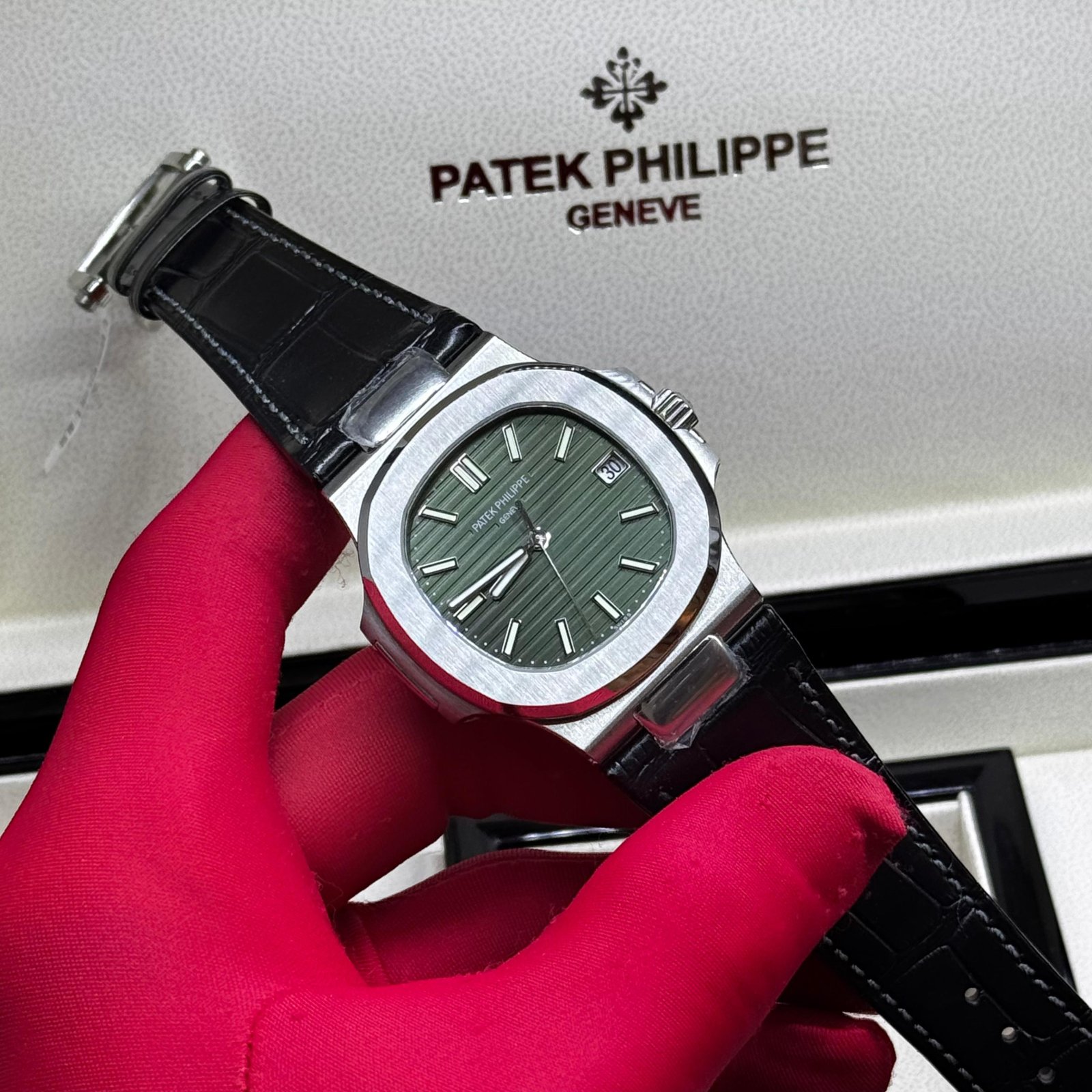 PATEK PHILIPPE Patek Philippe Nautilus Reference 5711 featuring a distinctive olive green horizontally-embossed dial and a black alligator leather strap